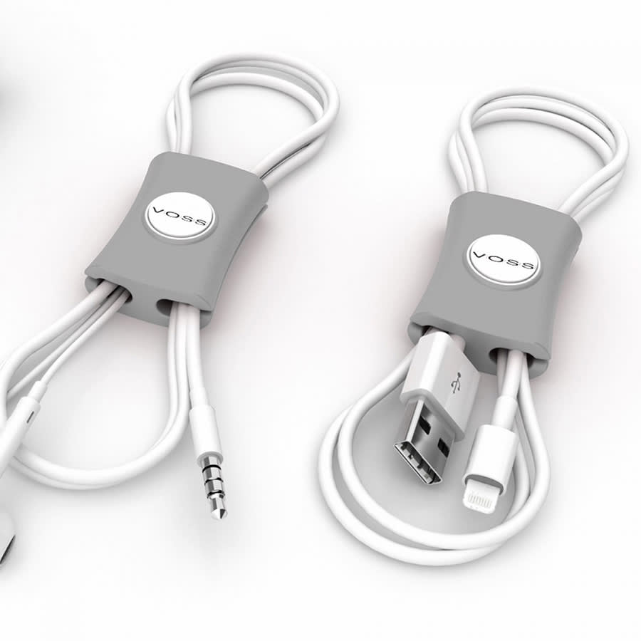 A grey cable manager with multiple slots for organising white cables, featuring a circular logo.