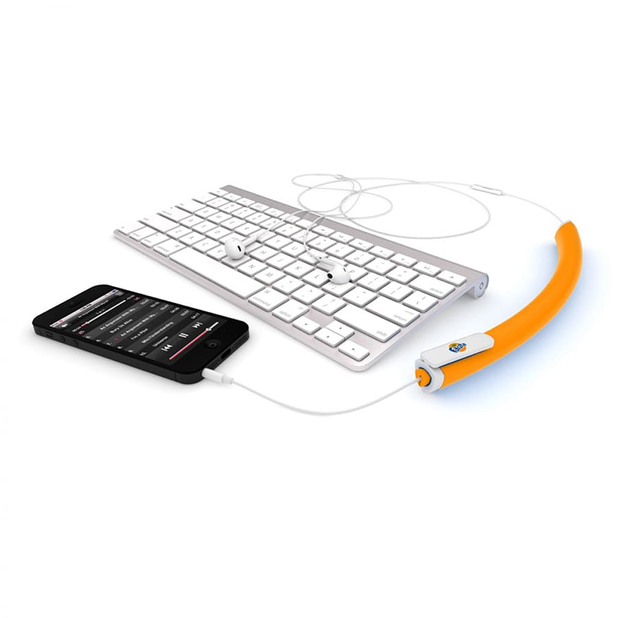 An orange earbud organiser connects to a smartphone, with earbuds and a white keyboard in the background.
