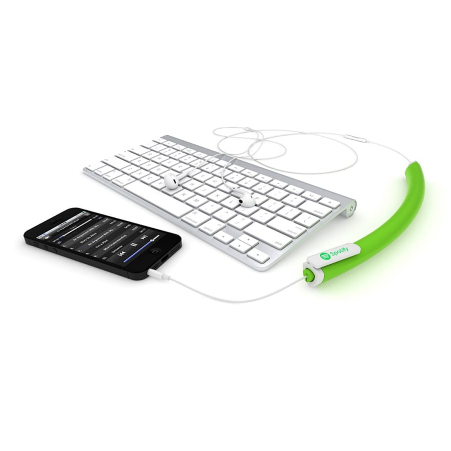 A green earbud organiser connected to a phone and a keyboard, managing tangled headphones.