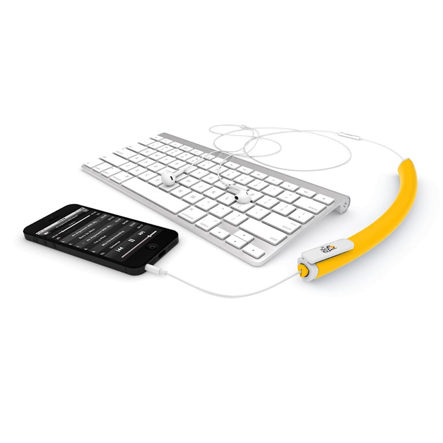 A yellow earbud organiser beside a keyboard and a smartphone, with earbuds neatly arranged on the organiser.