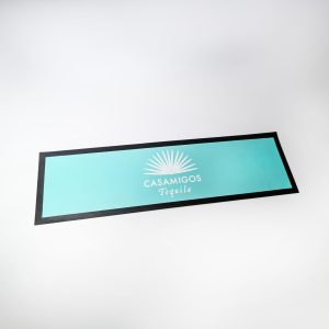 A bar runner featuring a turquoise colour with a black border and a logo design in the centre.