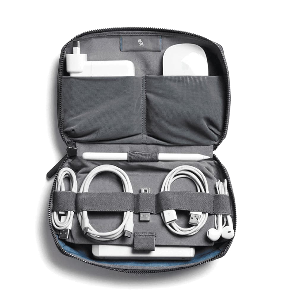 A black tech kit bag with a textured surface and a zip closure, featuring a branding logo.