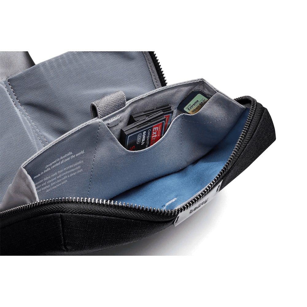 A navy blue tech kit with a tan interior, featuring card slots and a zippered closure. Contains organisational pockets.