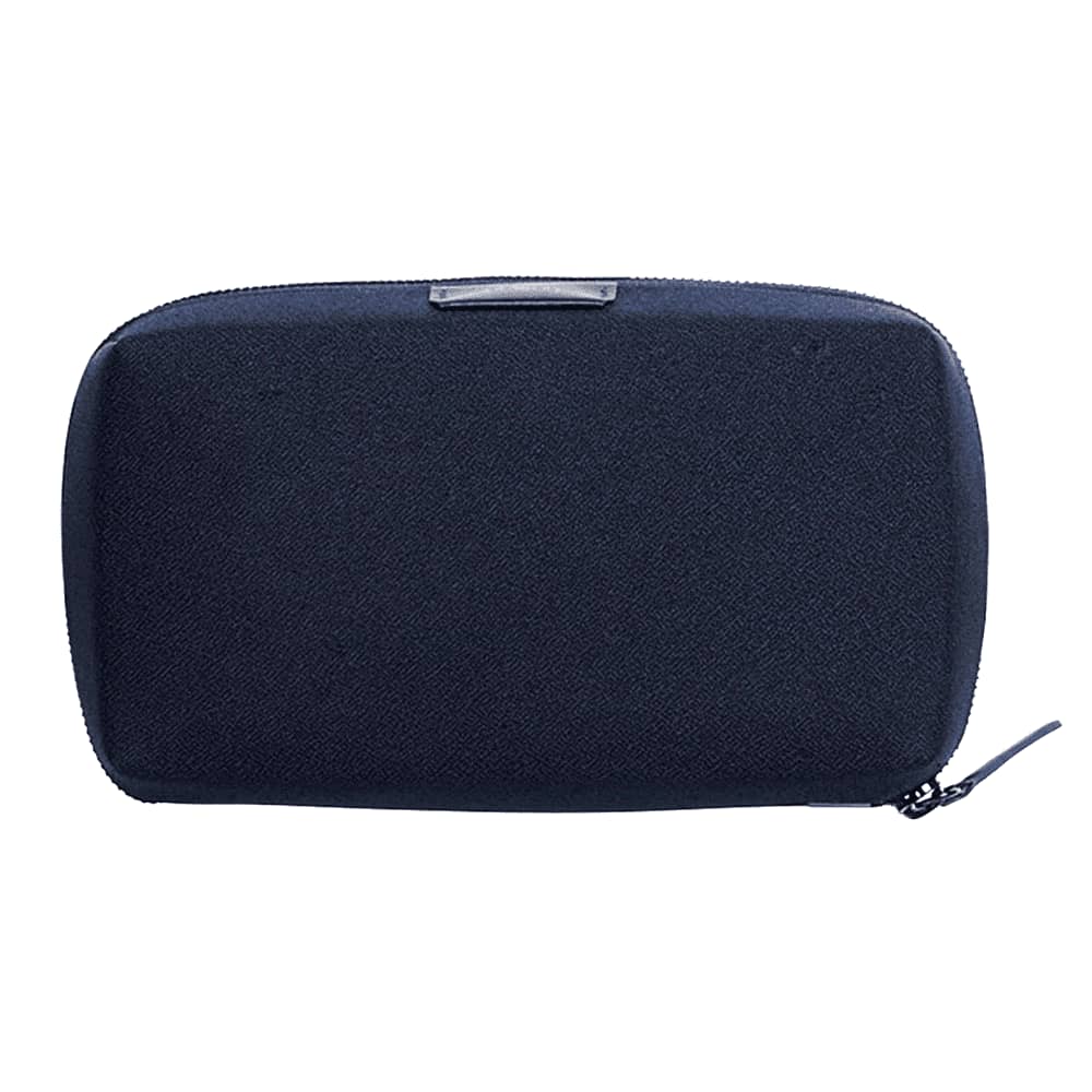 A hand holding a dark navy tech kit with a zippered closure, featuring a minimalist design and branding.