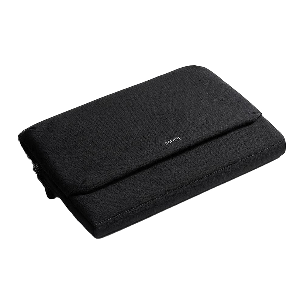 A black laptop caddy is held by a person, featuring a logo on the front and a sleek design.