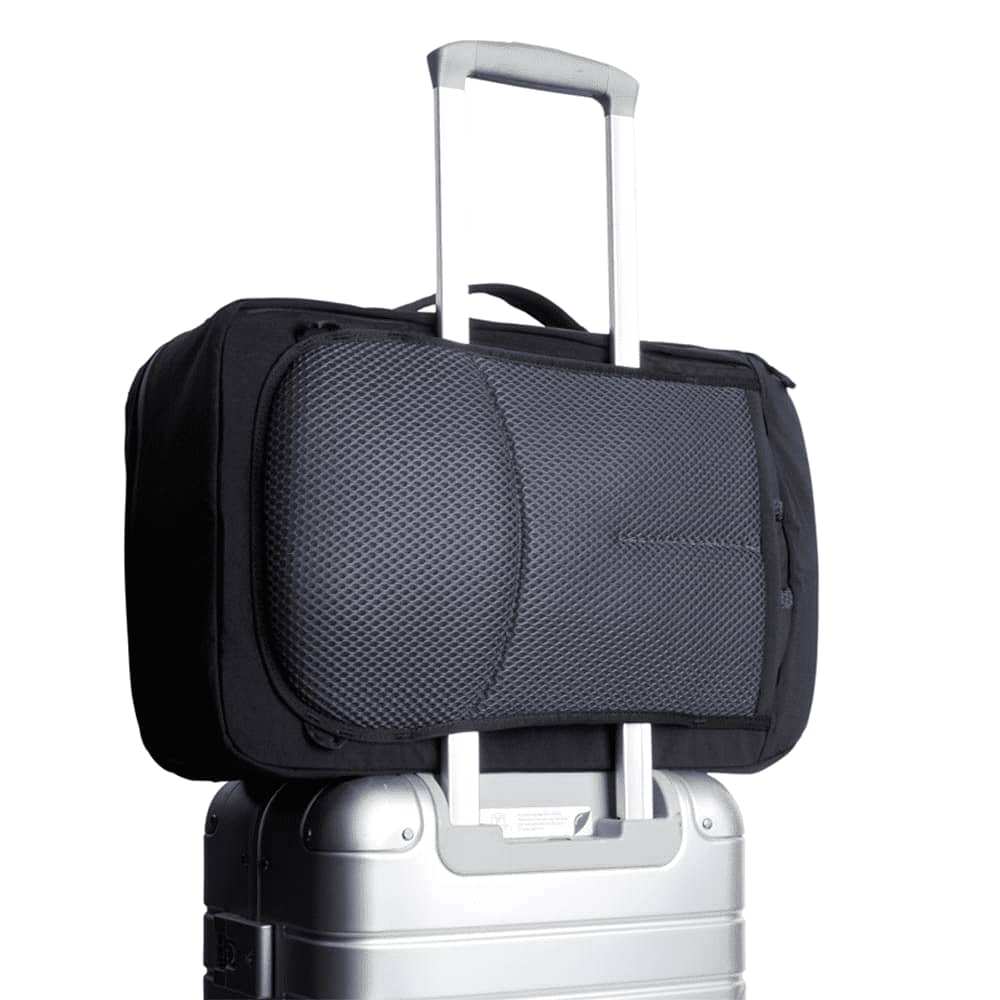 A black backpack features a carabiner and a small attached pouch, showcasing its versatile design.