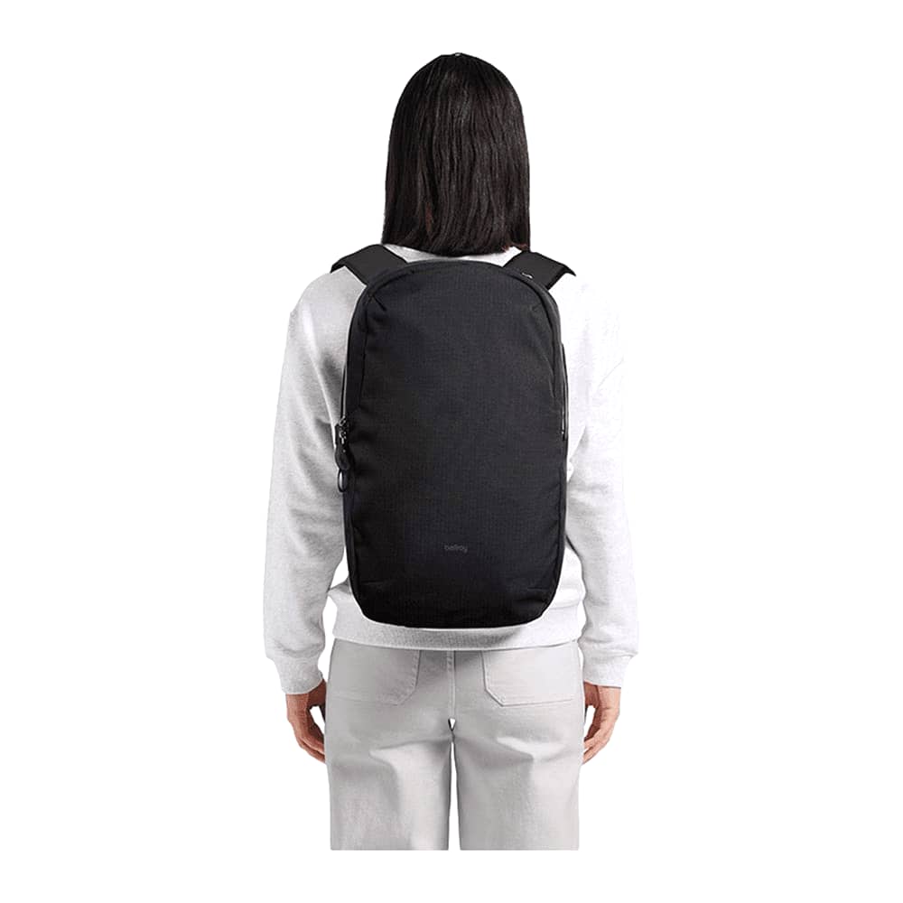 A navy backpack with a sleek design, featuring padded straps and a logo. Dual zip closures on the front and side.
