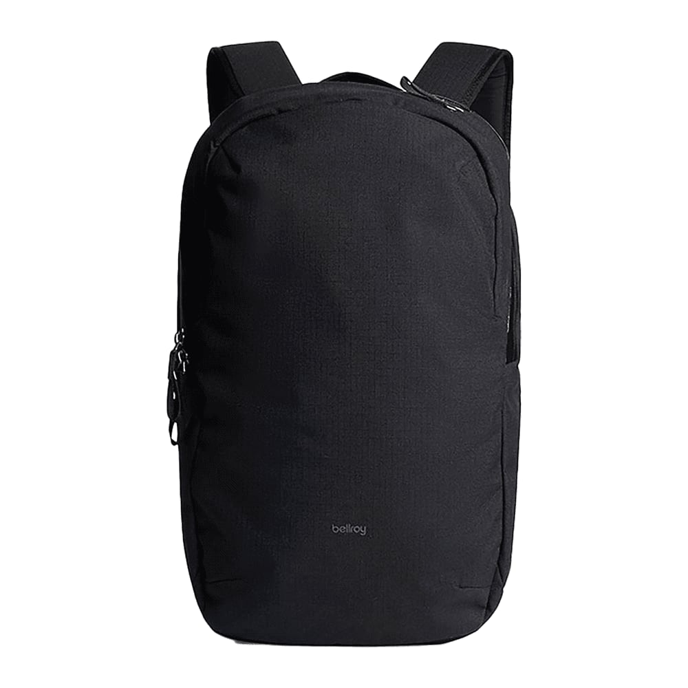 A black Bellroy Via Backpack 20L surrounded by a laptop, drink bottle, sunglasses, and various accessories.