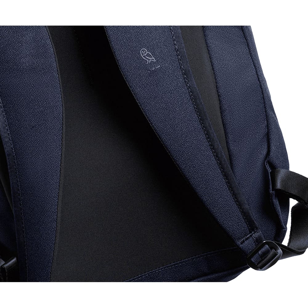 A black backpack interior featuring a textured lining and adjustable straps, with a logo on the inner fabric.