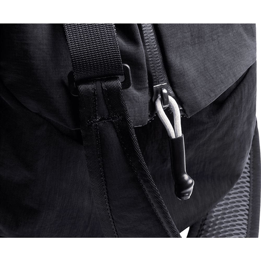 A black duffel bag with two handles and a zip closure, featuring a subtle logo on the front.