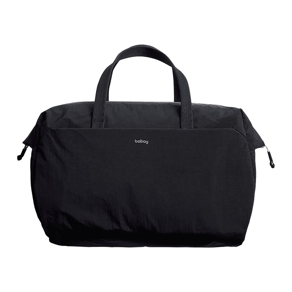 A black duffel bag with dual top handles and a detachable shoulder strap, featuring a logo.