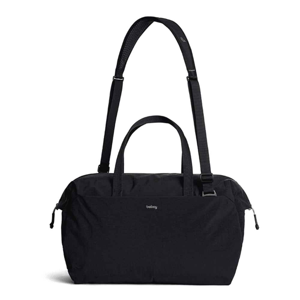 A black duffel bag with short handles and a branding logo on the front.