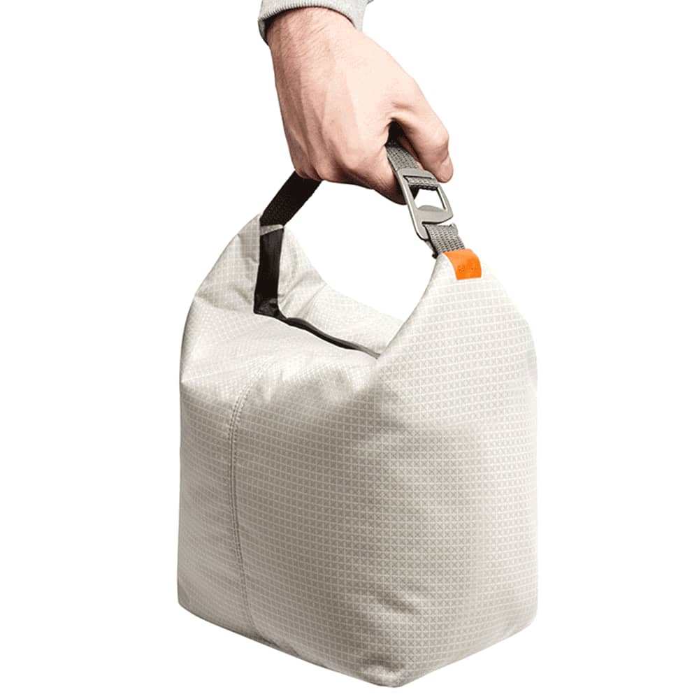 A grey cooler bag with a zipper, containing several drink bottles with golden caps inside.