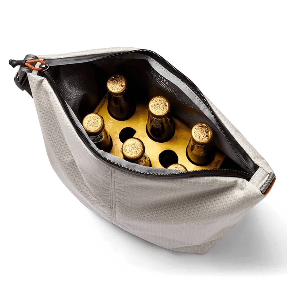 A cooler bag in light grey, accompanied by an ice pack and a four-pack of bottled drinks, showcasing its functionality.
