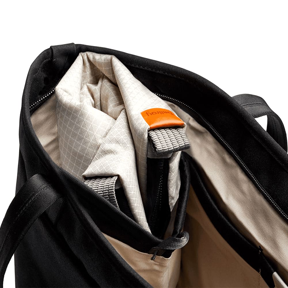 A hand holds a light grey cooler bag with a sturdy handle and a clip attachment.