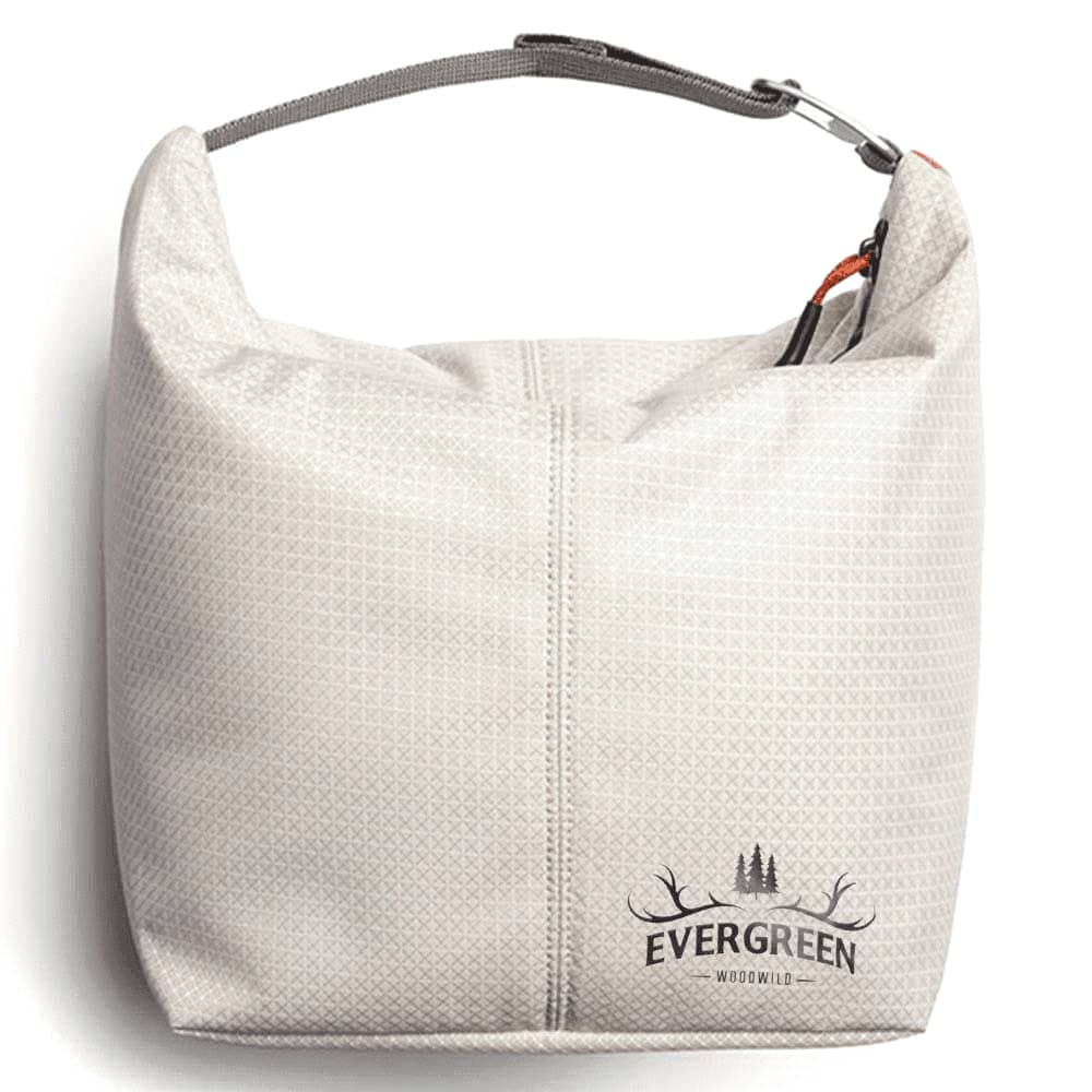 A grey cooler bag sits on a tiled surface near a pool, featuring a carry handle and a branded logo.