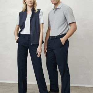 A man and woman stand together. The man wears grey polo and navy slacks; the woman wears a white t-shirt, navy vest, and navy trousers.