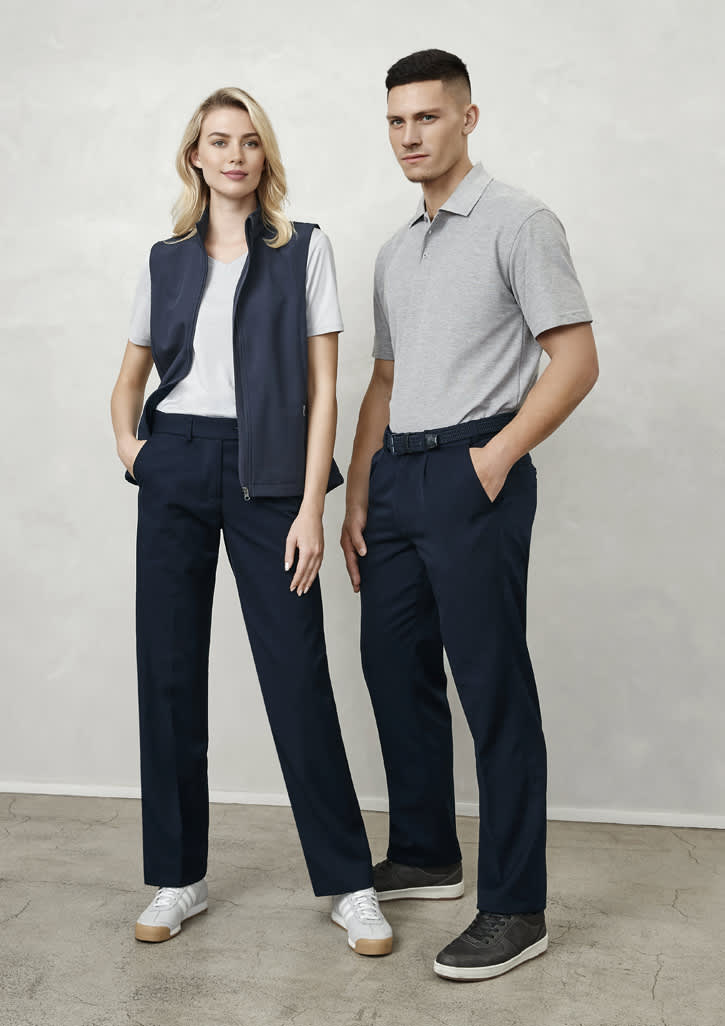 A man and woman stand together. The man wears grey polo and navy slacks; the woman wears a white t-shirt, navy vest, and navy trousers.