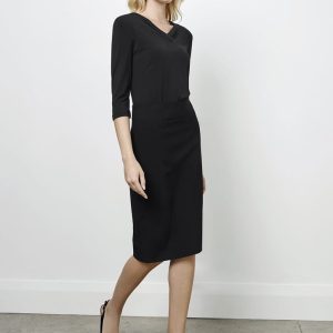 A black below-knee skirt paired with a three-quarter sleeve top, modelled by a woman in high heels.