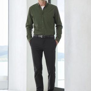 A pair of black men's venture pants displayed on a model, paired with a green shirt and brown shoes.
