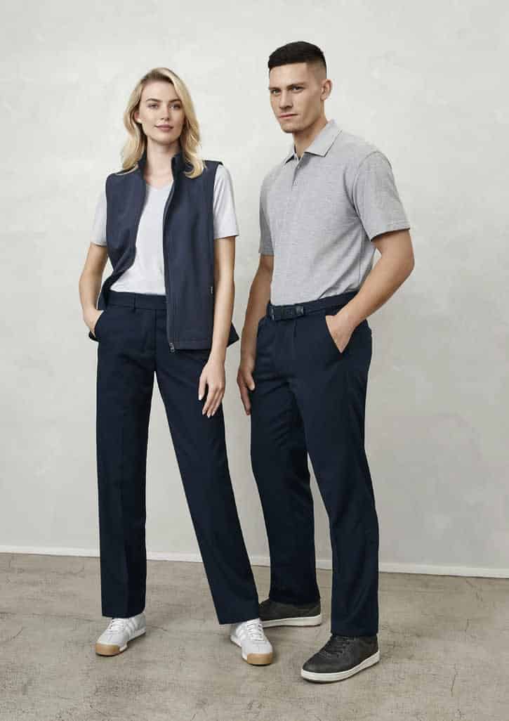 A woman in navy pants and a grey vest stands beside a man in grey polo and navy pants, both with shoes.