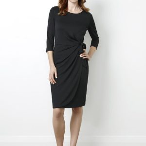 A black women's dress featuring a twist detail at the waist and three-quarter sleeves, paired with black heels.