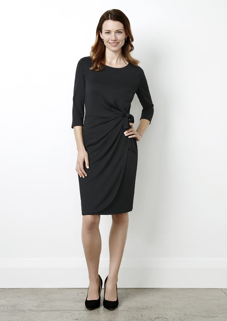 A black women's dress featuring a twist detail at the waist and three-quarter sleeves, paired with black heels.
