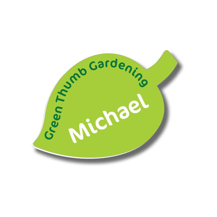 A green leaf-shaped badge featuring text and a logo, with a glossy finish.