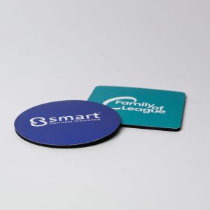 A blue circular coaster and a square black coaster, each featuring different logos, both Australian made.
