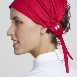 A red chef bandana with a tied back design, featuring a logo, worn by a person in a white chef uniform.