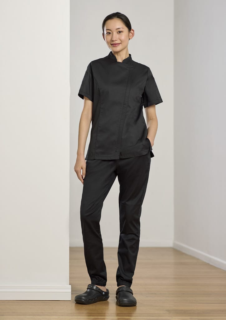 A black women's chef uniform featuring a short-sleeve top and jogger pants, paired with black clogs.