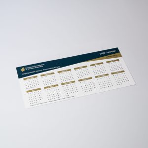 A white magnetic calendar featuring a clean layout with multiple months displayed and a logo in the corner.