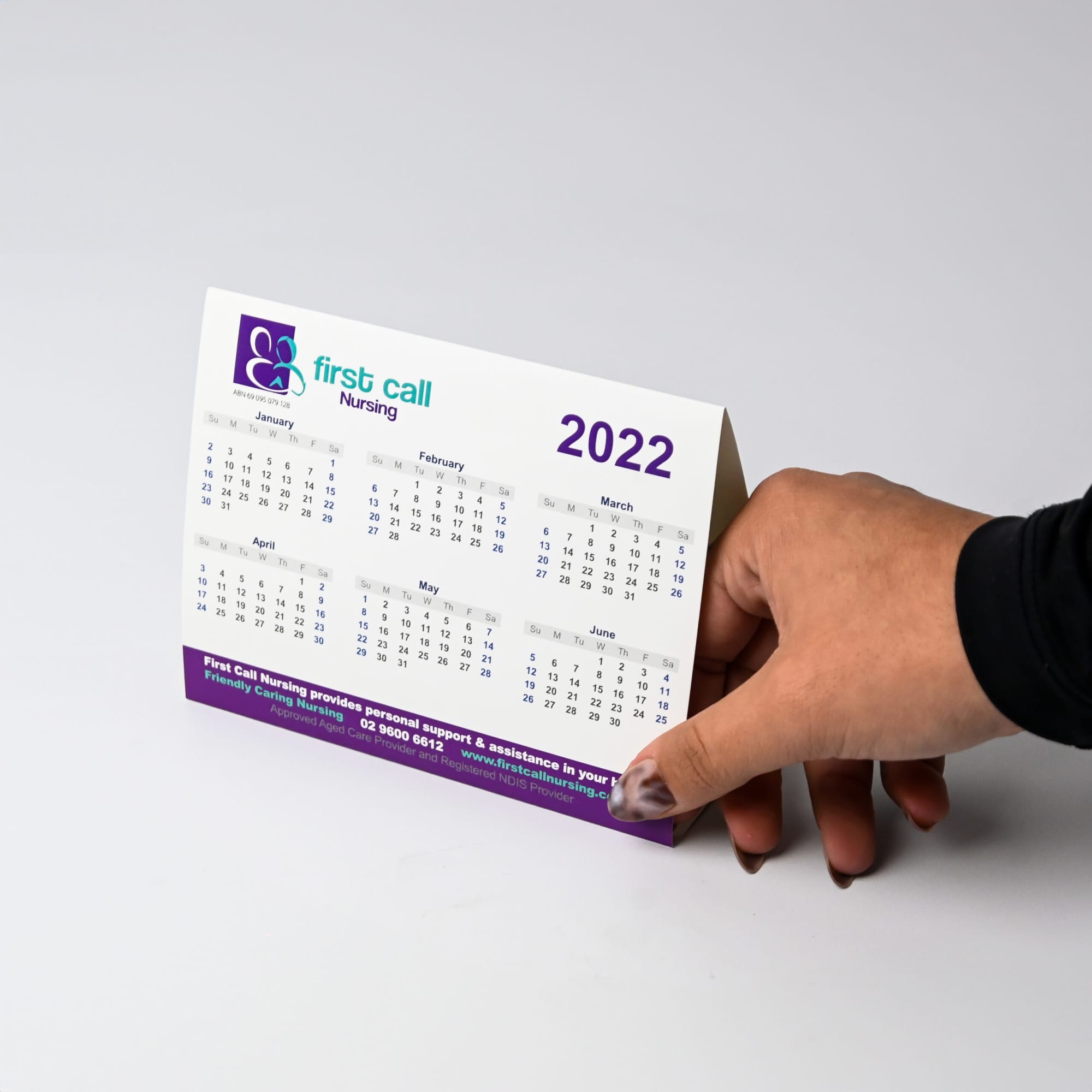 A desk calendar featuring months from January to June, with a predominantly white background and purple accents.