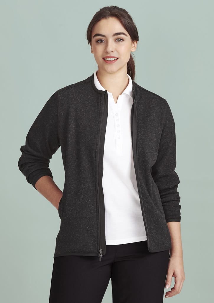 A women's zip front jumper in dark grey with a zip closure and long sleeves, paired with a white polo shirt.