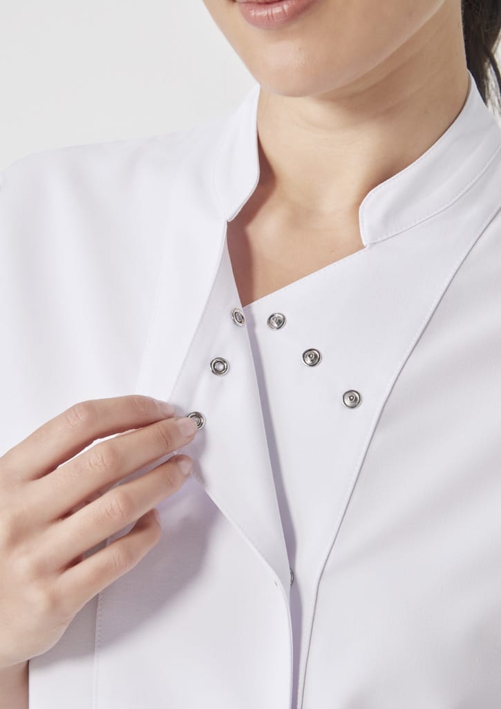 A white women's jacket featuring a snap button closure. The fabric appears smooth and contemporary.