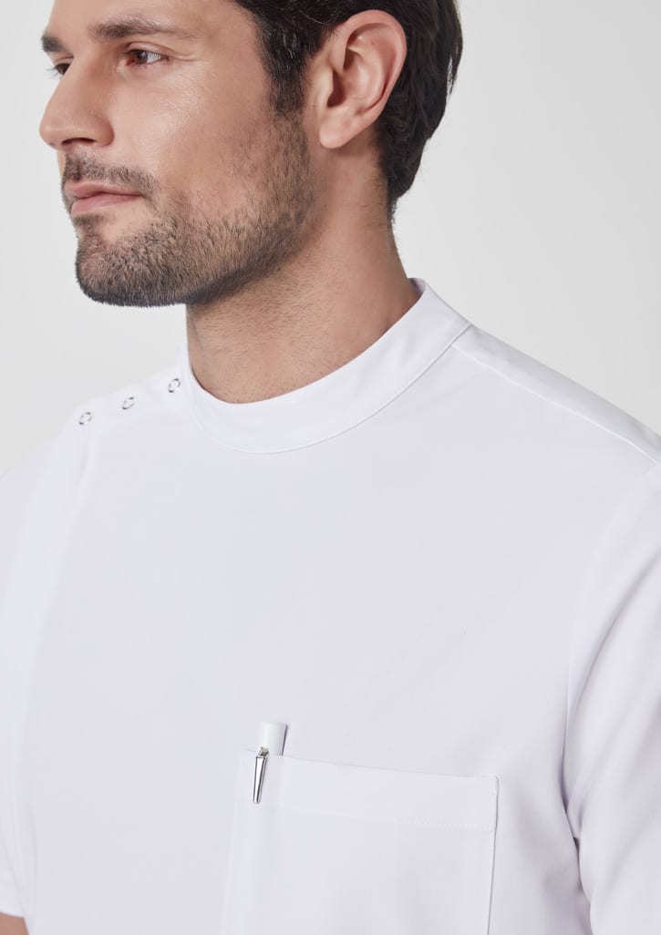 A close-up of a man wearing a white jacket with a high collar and a pocket, featuring a logo on the chest.