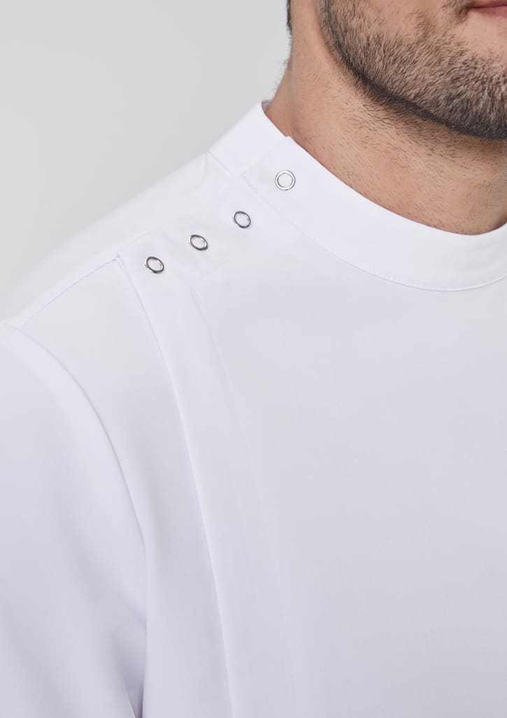 A close-up of a white jacket featuring a high neck and decorative snap details on the shoulder, with a logo.