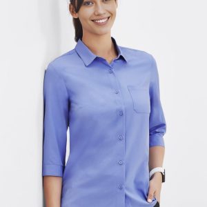 A blue women's button-up shirt with 3/4 sleeves and a chest pocket, displayed on a model.