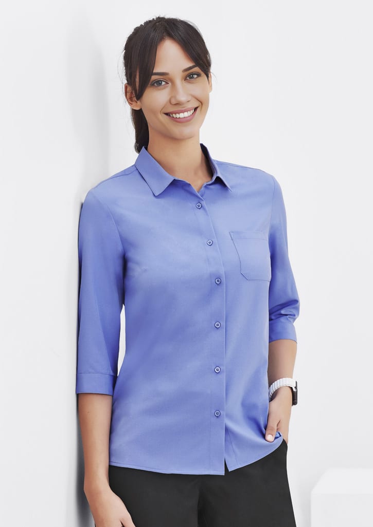 A blue women's button-up shirt with 3/4 sleeves and a chest pocket, displayed on a model.
