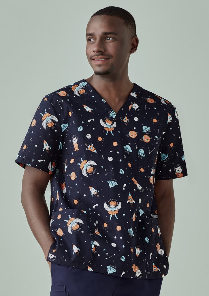 A men's scrub top featuring a navy background with colourful space-themed prints, including rockets and planets.