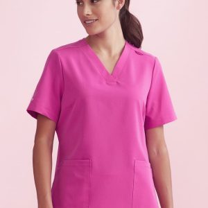 A pink women's V-neck scrub top with short sleeves and two front pockets. It features a logo on one sleeve.