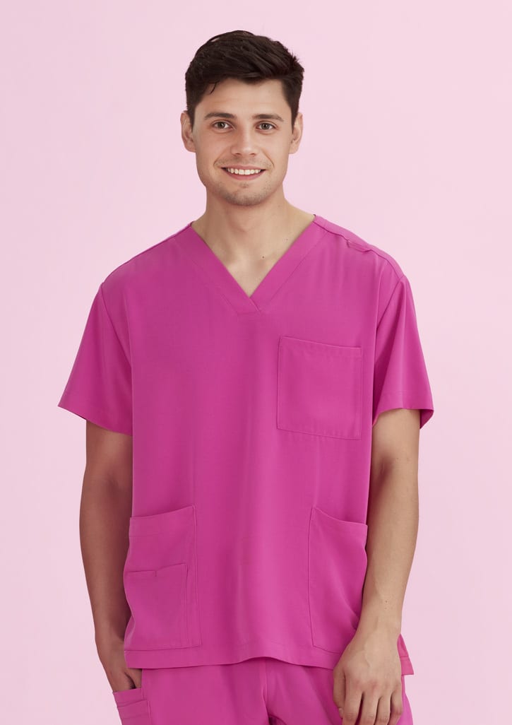 A unisex pink V-neck scrub top displayed on a model, featuring a pocket on the front and an overall bright colour.