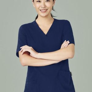 A women's navy V-neck scrub top with short sleeves and two front pockets, featuring a logo.