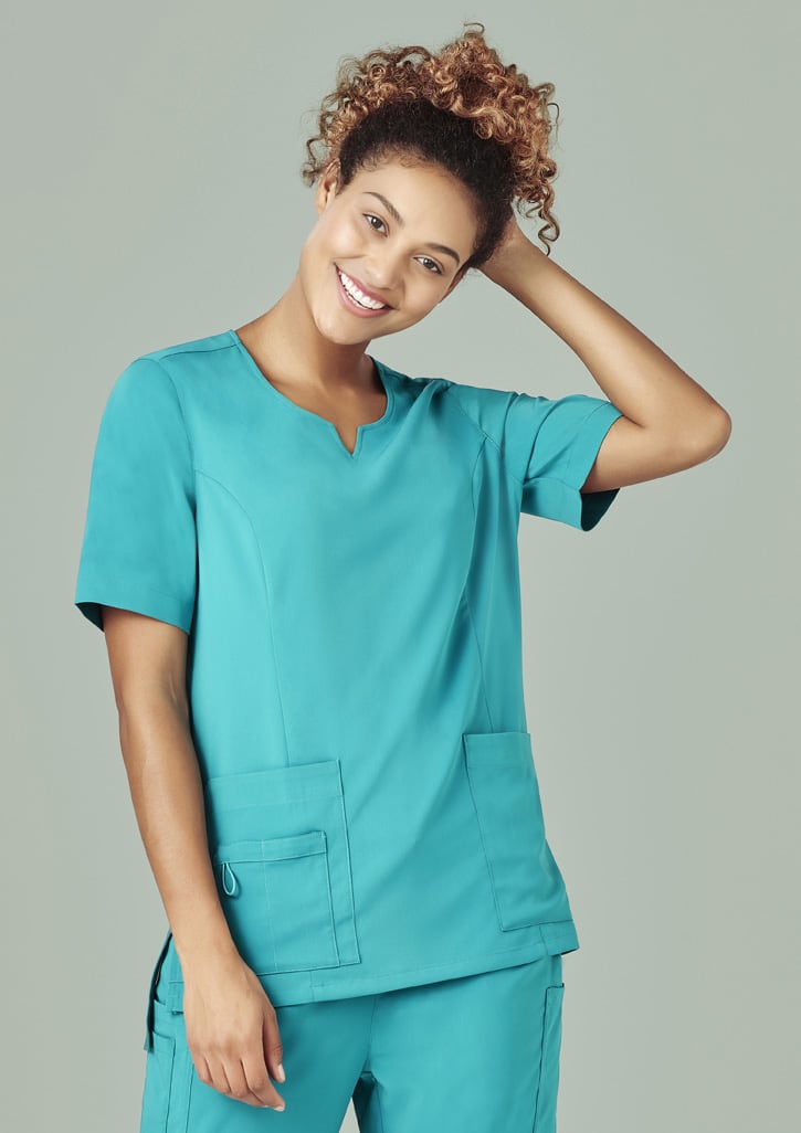 A women's scrub top in teal with a round neck, featuring short sleeves and front pockets.