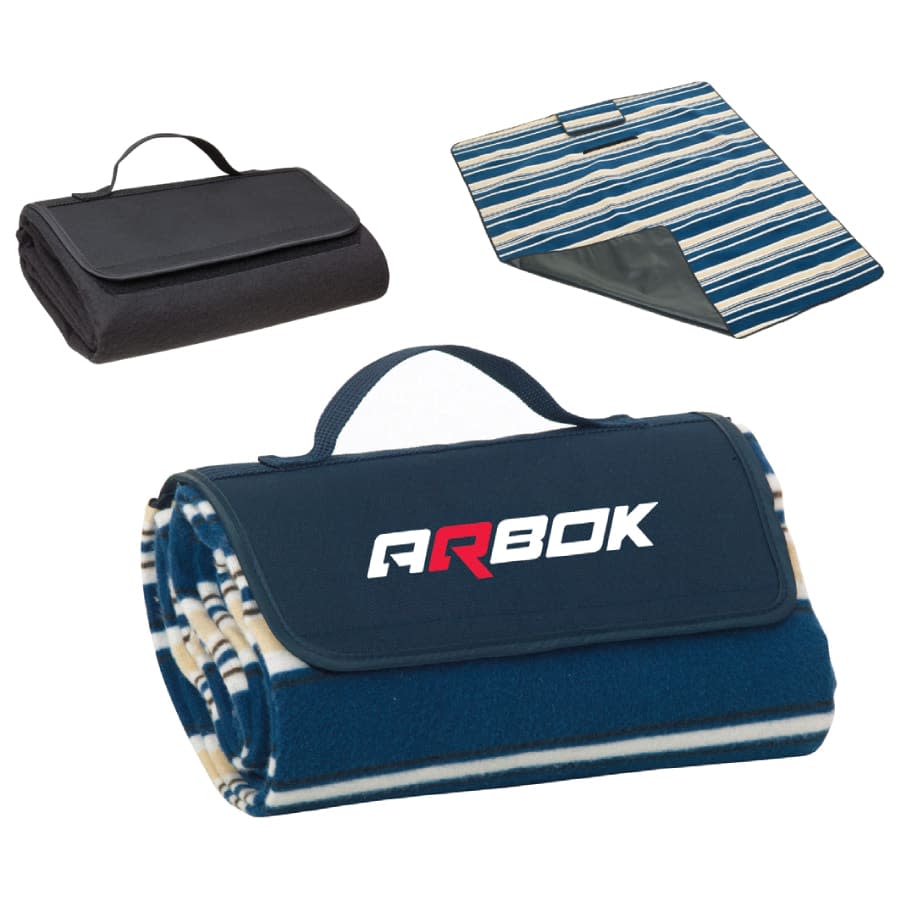 A rolled-up blue and cream-striped picnic rug with a black carry handle and branding, plus a folded black version.