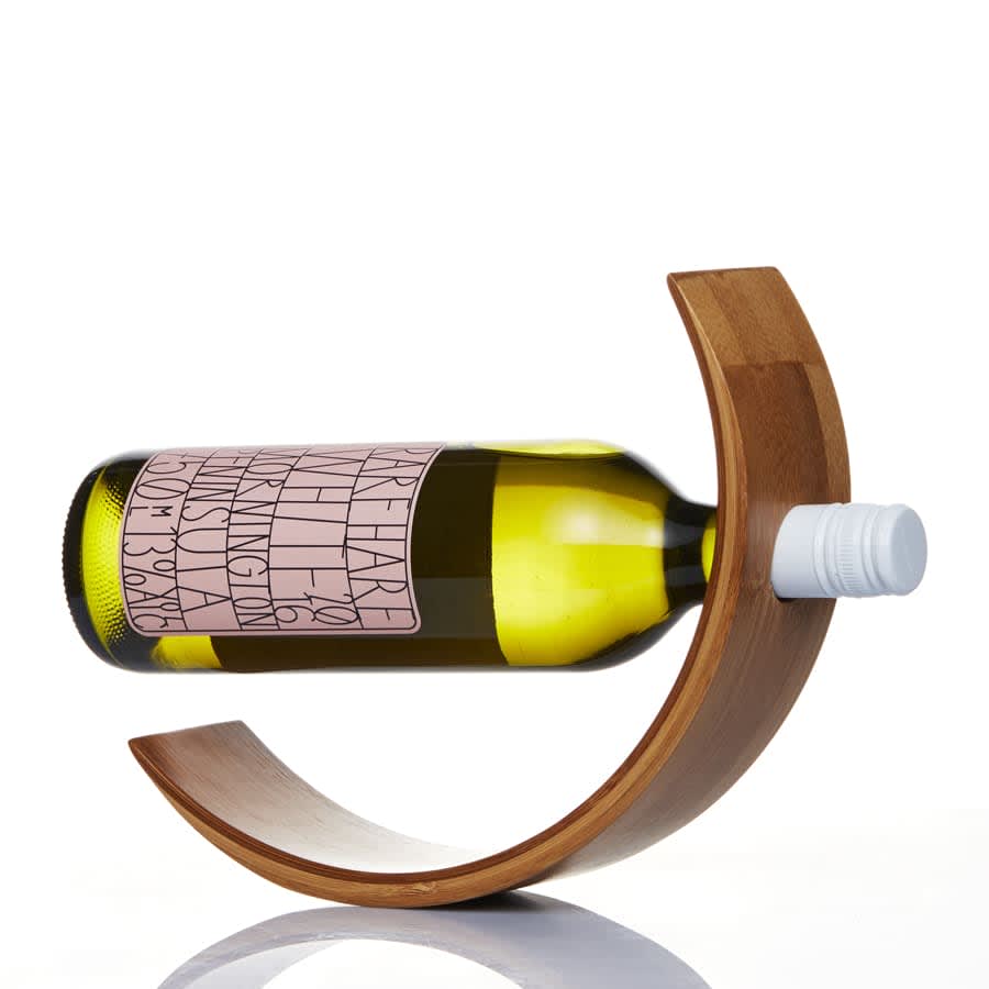 A drink bottle resting in a curved bamboo wine holder, featuring a green glass design. The holder has a natural wood finish.