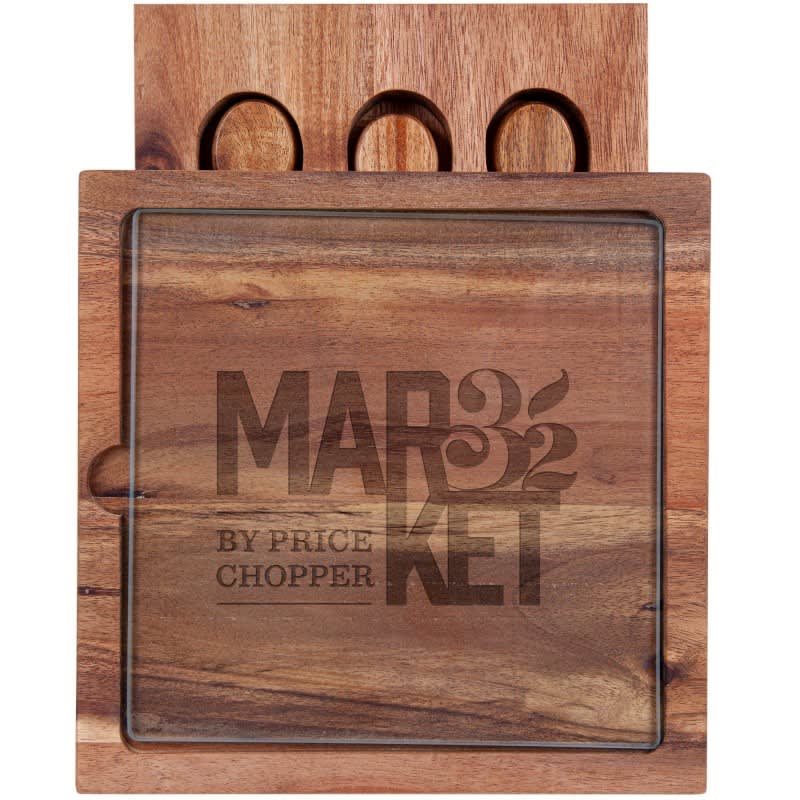 A wooden cheese board with a glass top and three circular cut-outs, featuring branding on the surface.
