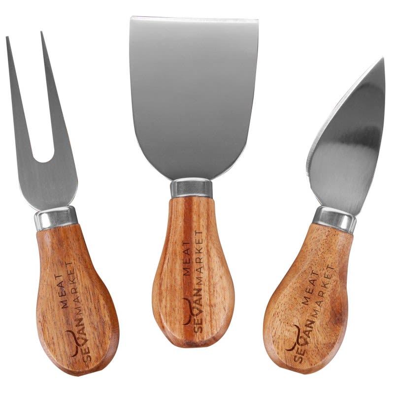 A cheese knife set featuring three stainless steel knives with wooden handles. Includes a fork, a spade, and a curved knife.