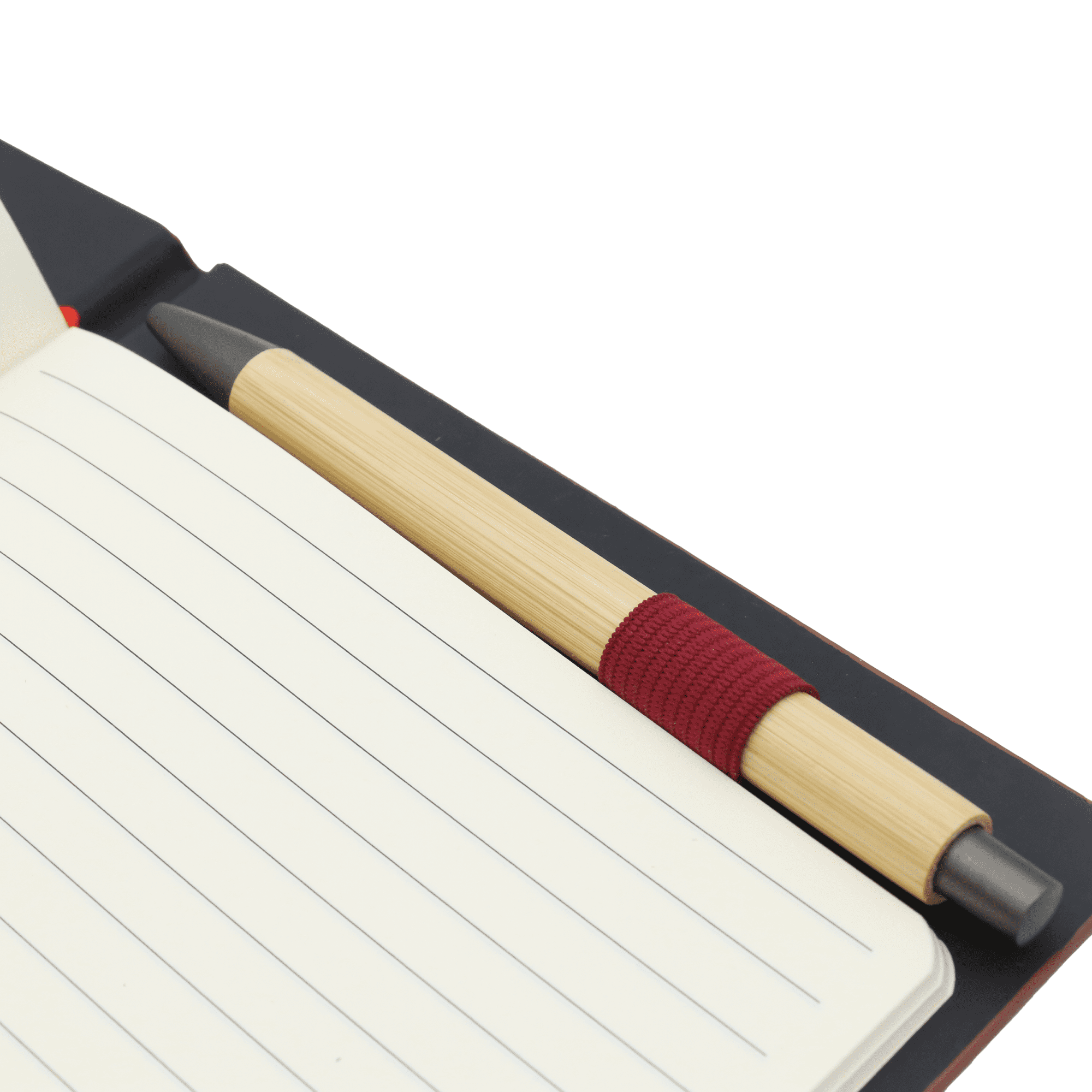 A dark notebook with lined pages and a bamboo pen with a red grip placed inside.