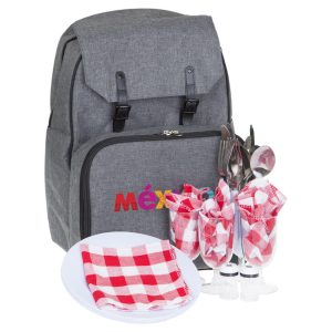 A grey picnic backpack with cutlery, plates, and checkered napkins displayed in front. The backpack features a logo.